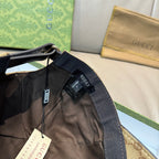 Gucci cap side with dark webbing strap and hanging labels