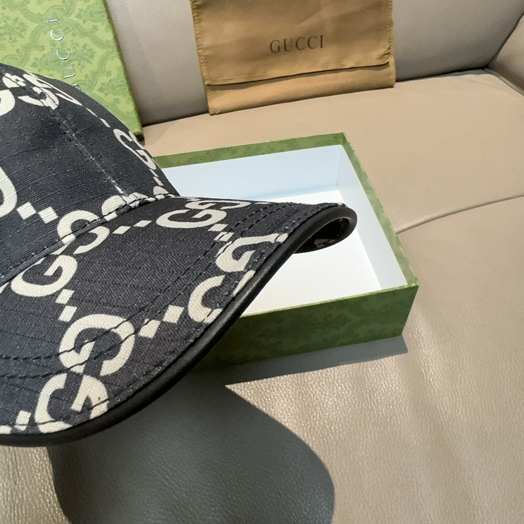 Gucci baseball cap brim close-up with black fabric and white GG monogram pattern