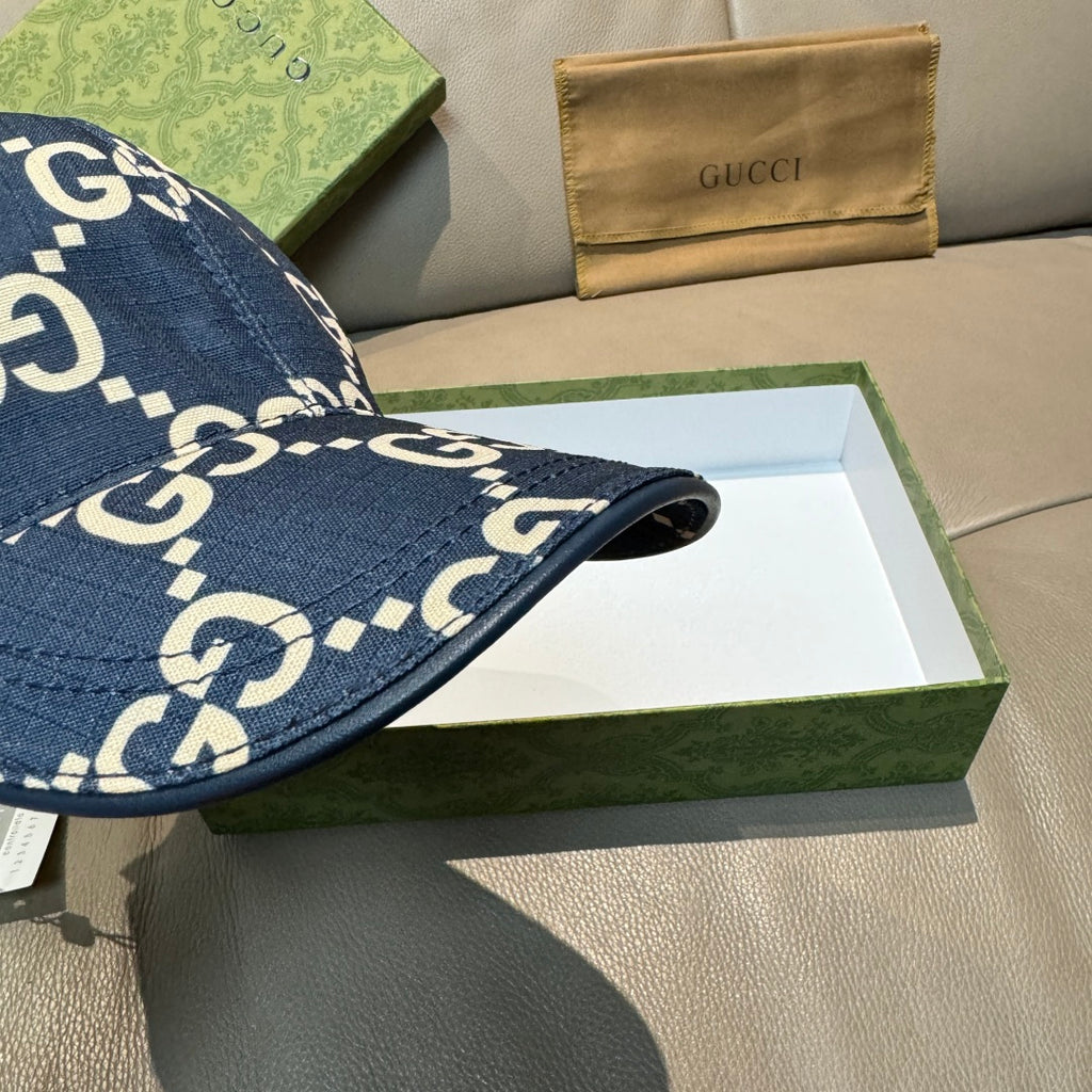 Navy denim baseball cap side view with white GG logo print and stitched brim edge