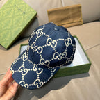 Navy denim baseball cap with white GG logo print and round top button; curved brim