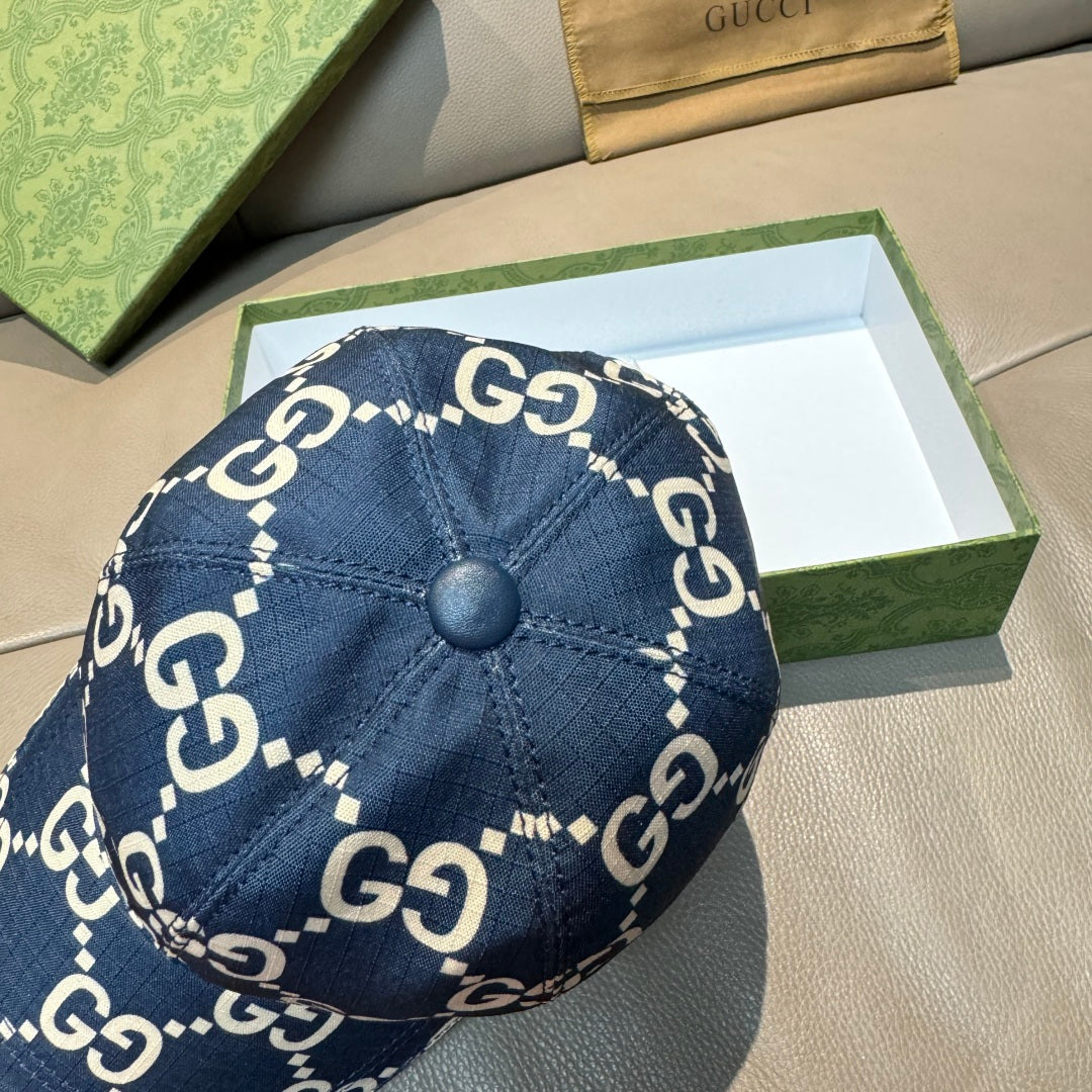 Navy denim baseball cap top view with white GG logo print and round button closure