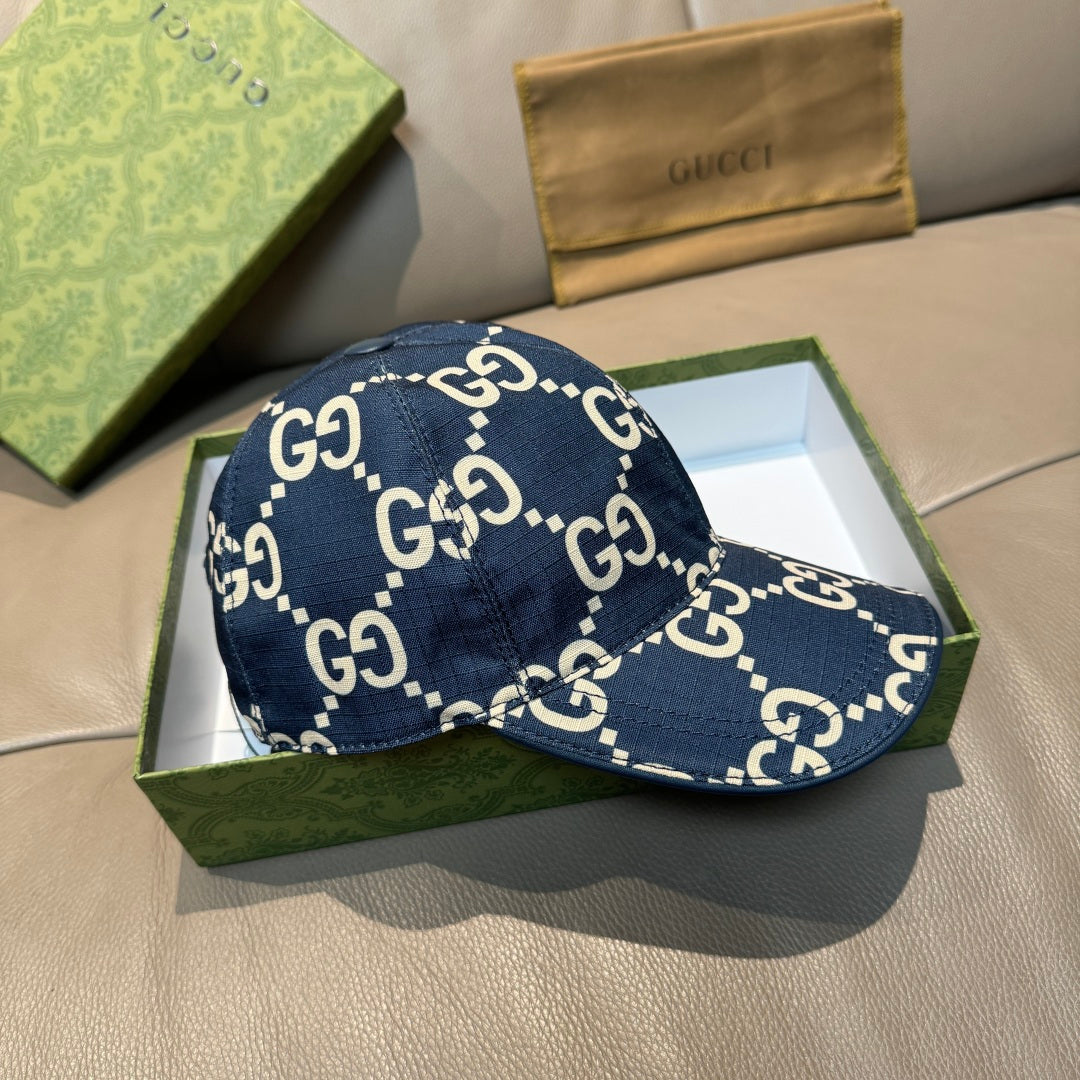 Navy denim baseball cap with white GG logo print and curved brim in open box