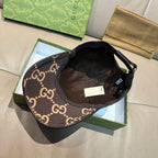 Gucci GG monogram cap with dark interior lining and brown/tan crown