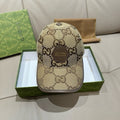 Gucci cap with beige GG monogram canvas and curved brim, adjustable strap.