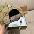 Gucci cap with beige GG monogram panel and logo patch on side strap.