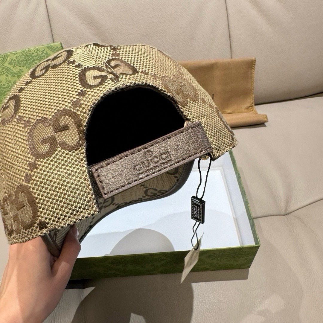 Gucci cap with beige GG monogram panel and logo patch on side strap.