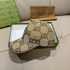 Gucci cap with beige GG monogram canvas, curved brim, side view on box.
