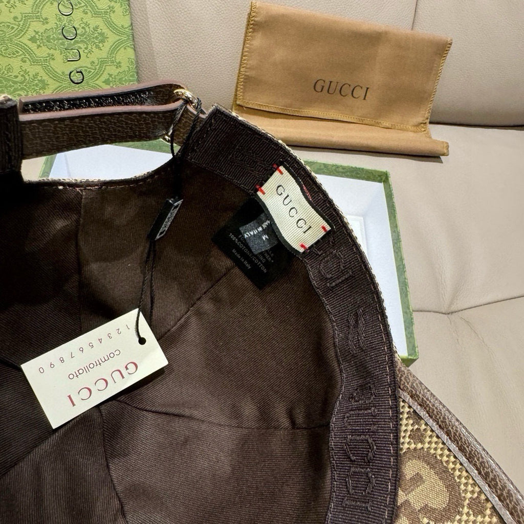 Gucci cap interior close-up with black lining and hanging tags.