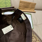 Gucci cap interior close-up with black lining and hanging tags.