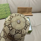Gucci cap top view with beige GG monogram fabric and button crown.