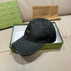 Black monogram baseball cap in open box, curved brim and top button