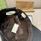 Inside of black cap showing fabric panels and hanging care tags