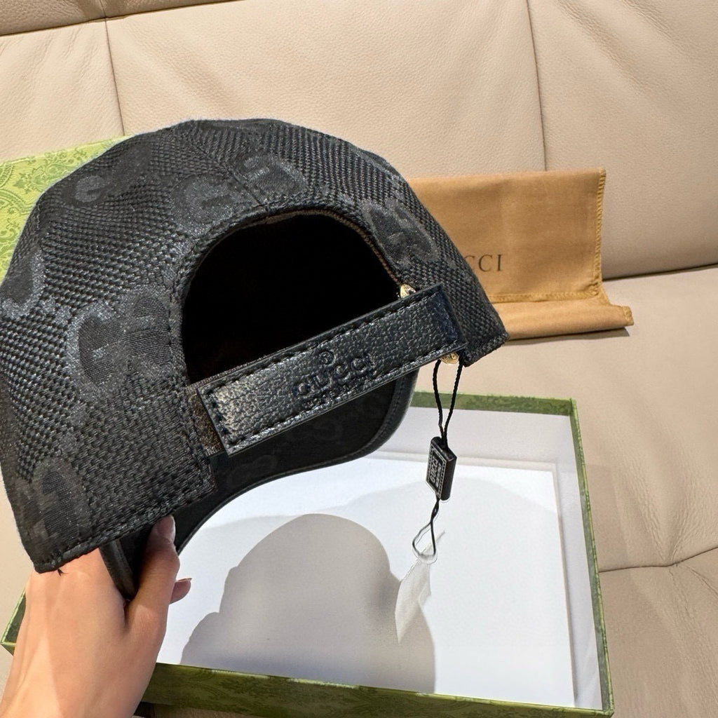 Black monogram cap underside view with adjustable strap and buckle