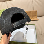 Black monogram cap underside view with adjustable strap and buckle