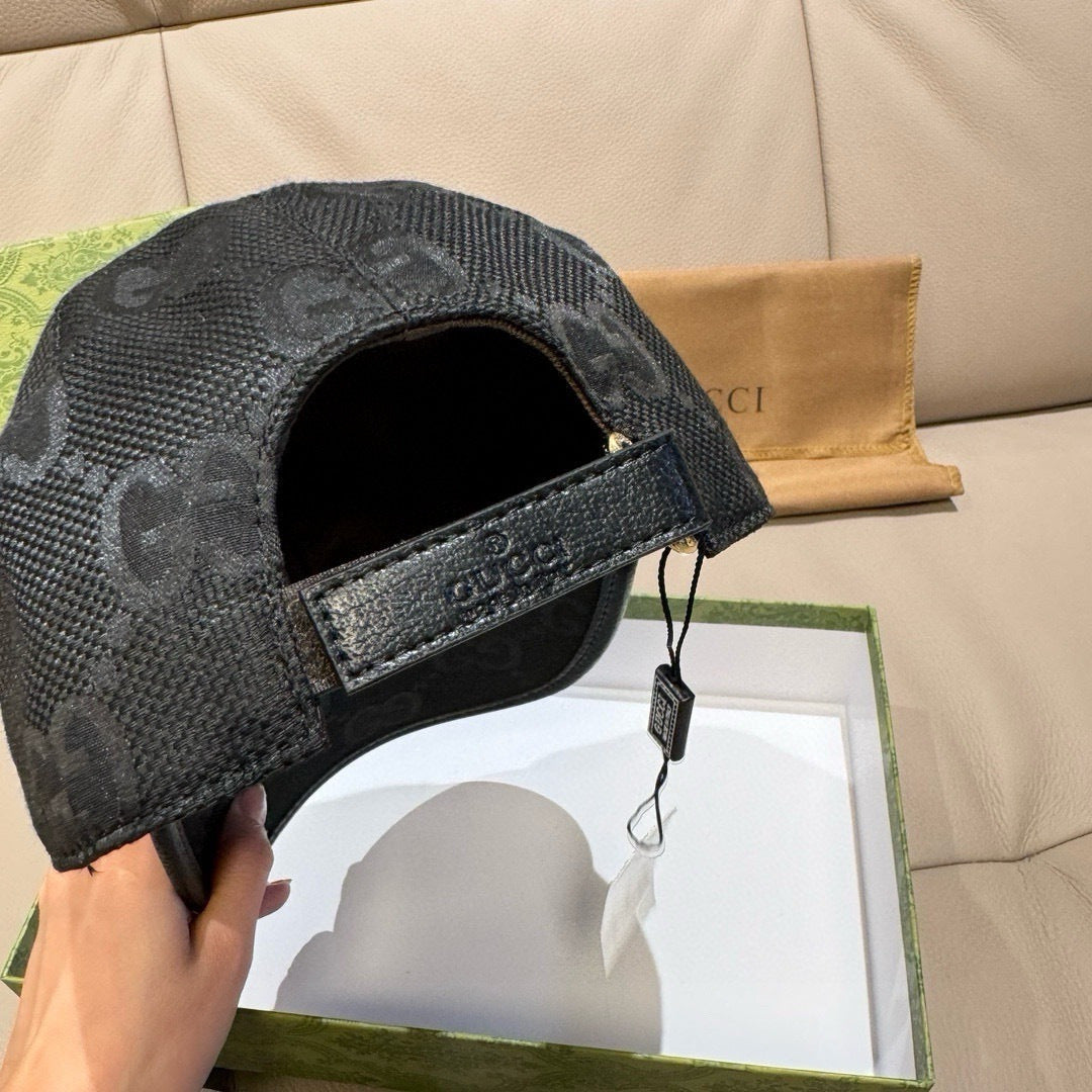 Black monogram cap underside view with adjustable strap and buckle