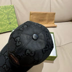 Black monogram baseball cap angled view with top button and stitched seams