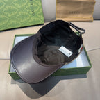 Black baseball cap with dark brim, open crown, and adjustable strap
