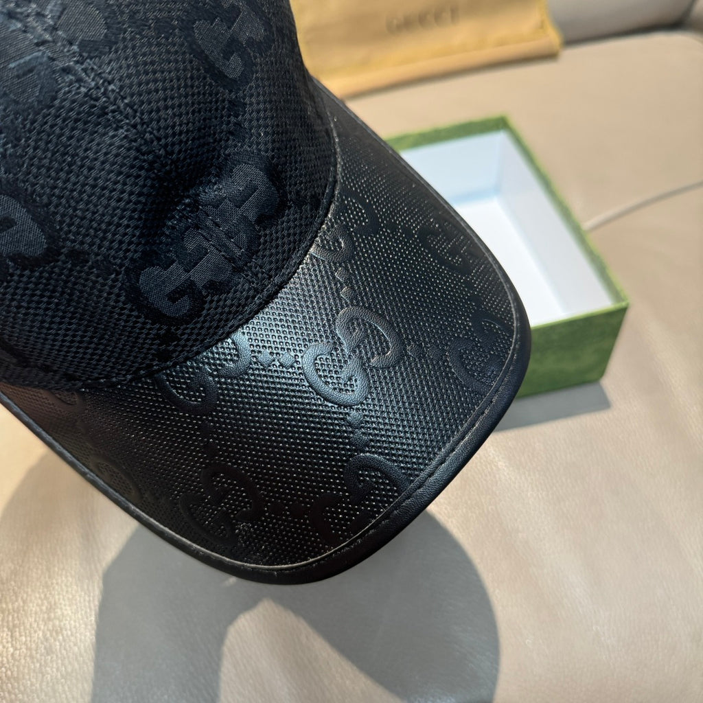 Gucci baseball cap brim close-up with repeating GG monogram and black trim