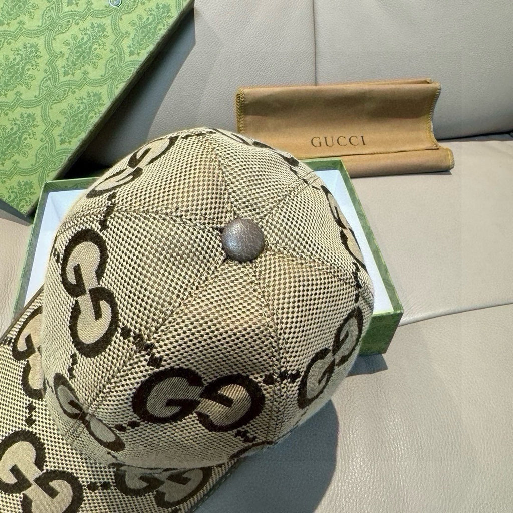 Gucci monogram baseball cap top panel, beige with dark brown GG pattern and button.
