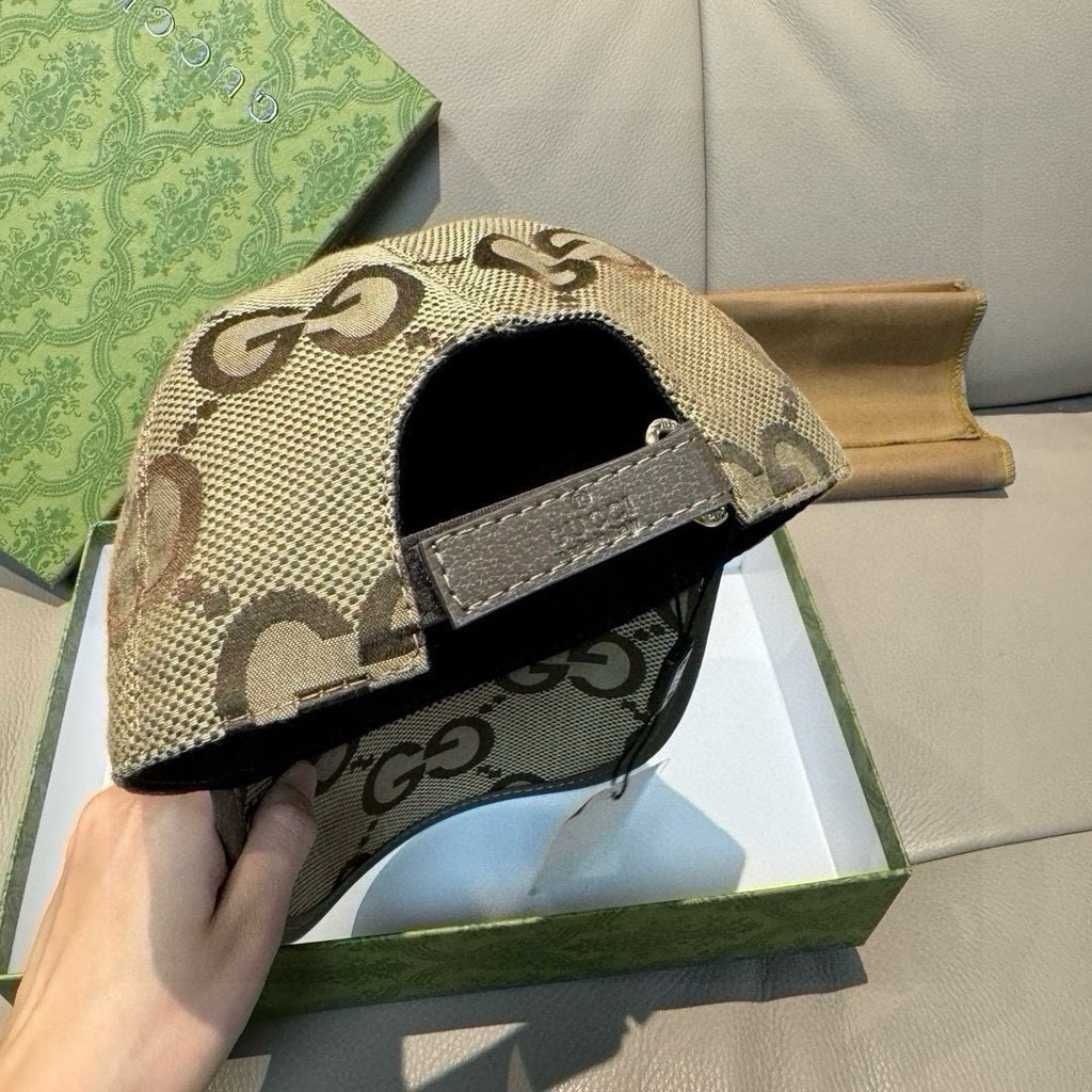 Gucci monogram baseball cap with black inner brim and beige GG logo crown.