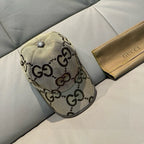 Gucci monogram baseball cap, beige GG pattern with gray button and curved brim.