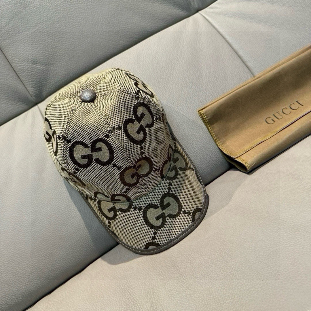 Gucci monogram baseball cap, beige GG pattern with gray button and curved brim.