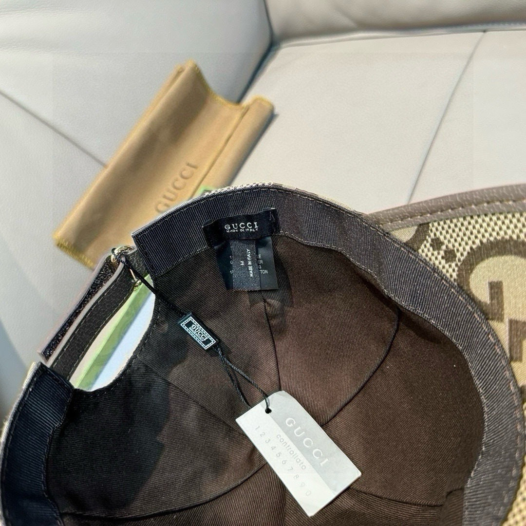 Gucci fabric baseball cap interior view, dark lining with brand and size tags.
