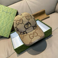 Gucci monogram baseball cap in beige with dark brown GG pattern and curved brim.