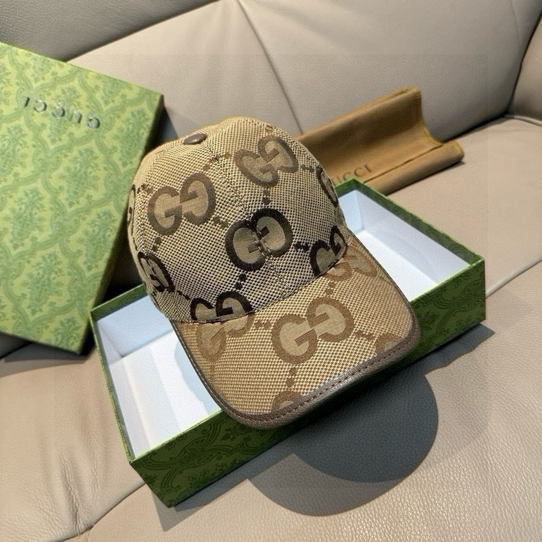 Gucci monogram baseball cap in beige with dark brown GG pattern and curved brim.