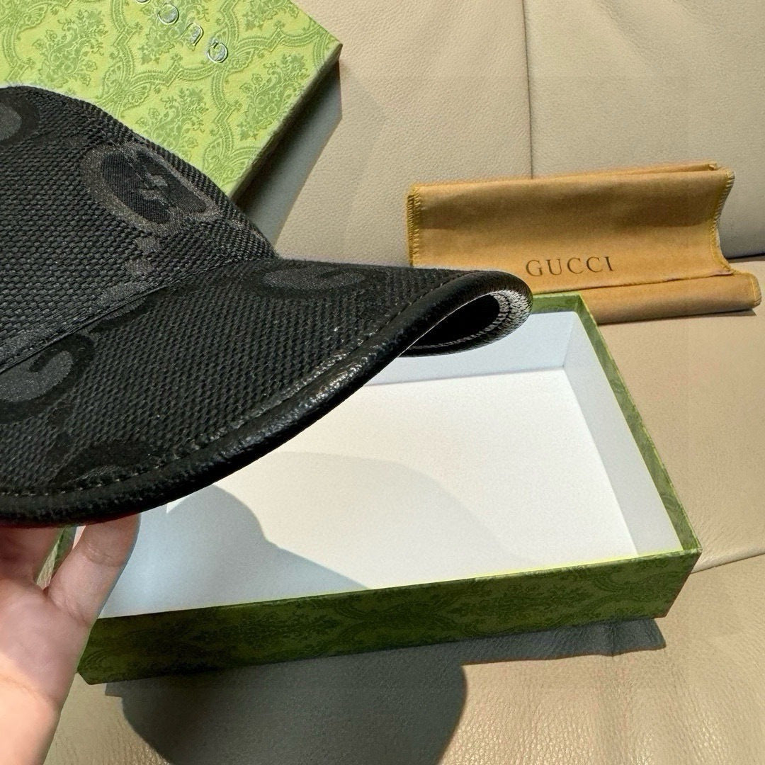 Gucci black GG-pattern baseball cap, close-up of curved brim and brim stitch