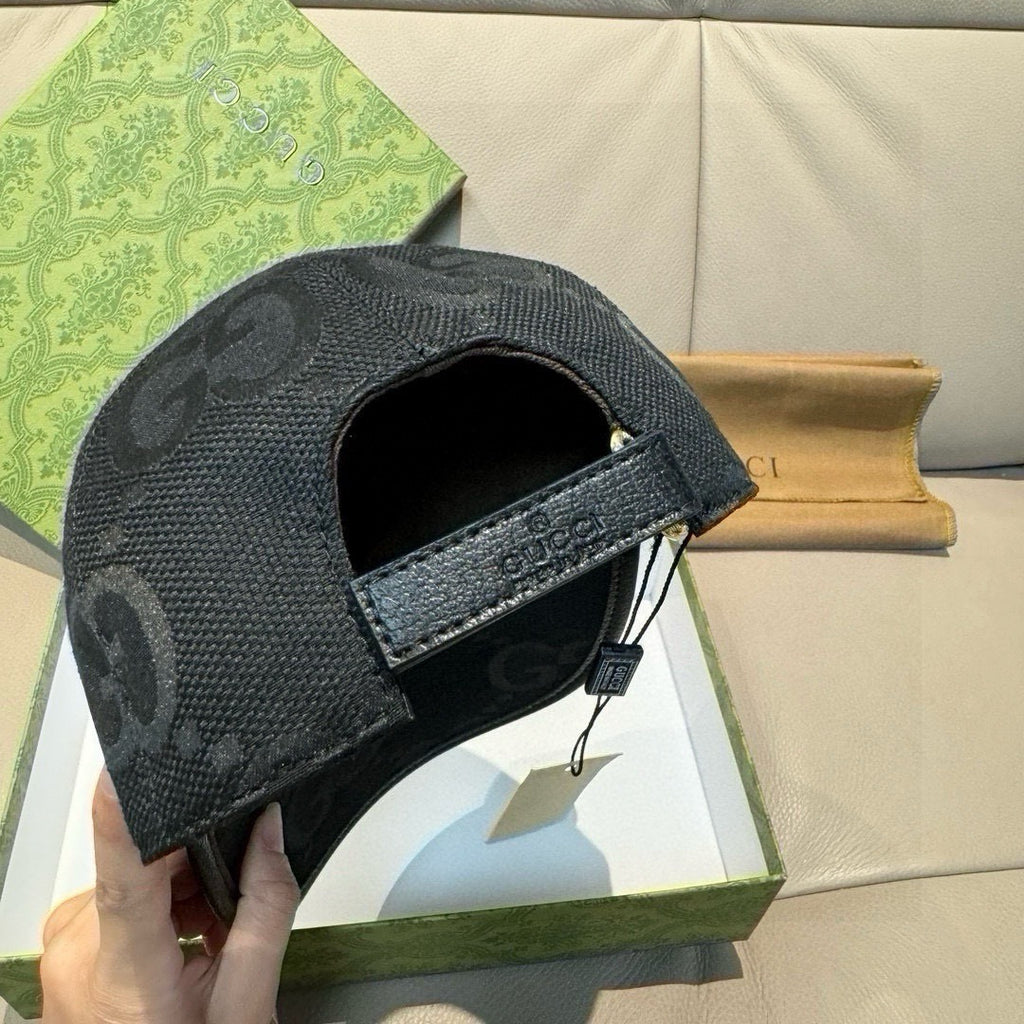 Gucci black GG-pattern baseball cap with leather side strap and metal buckle