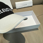 Two-tone baseball cap close-up of curved white brim and black crown seam