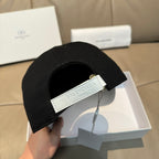 Two-tone baseball cap with adjustable strap and Balenciaga logo label on front