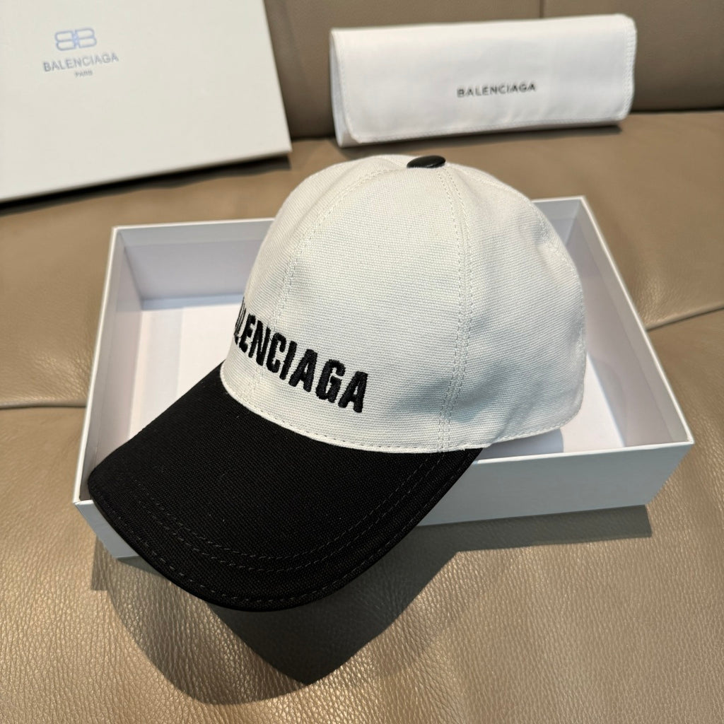 Two-tone baseball cap with BALENCIAGA lettering on light gray crown and black brim.