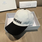 Two-tone baseball cap with BALENCIAGA lettering on light gray crown and black brim.