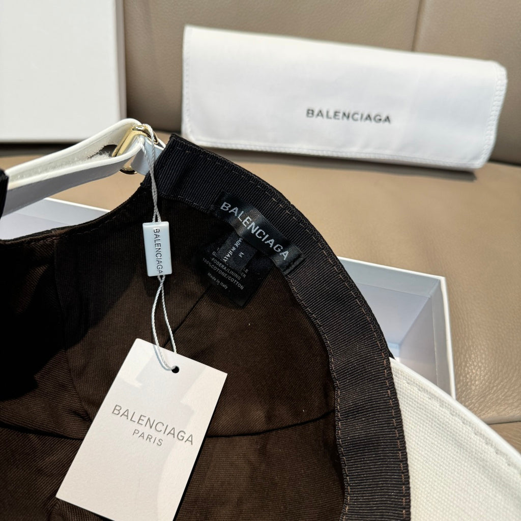 Two-tone baseball cap with hanging tag and Balenciaga webbing strap on side