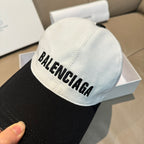 Light and black baseball cap with BALENCIAGA logo, close-up of front panel