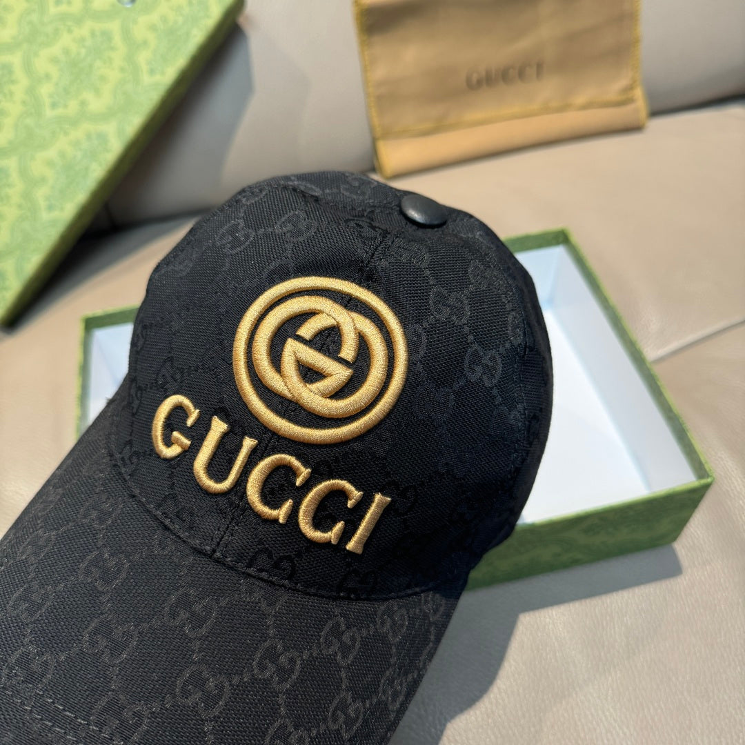 Black GG-pattern baseball cap close-up with gold circular logo and brim