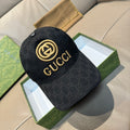 Black GG-pattern baseball cap with gold Gucci logo and curved brim