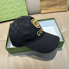 Black GG-pattern baseball cap with gold crest logo on crown