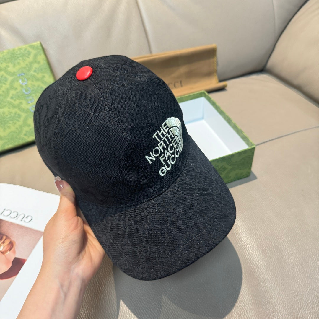 Black GG baseball cap angled view with The North Face Gucci logo and red button