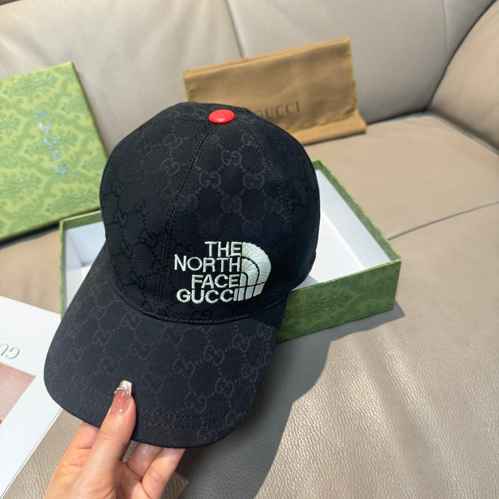 Black baseball cap with The North Face Gucci front patch and red button detail