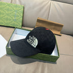 Black baseball cap with side The North Face Gucci logo and small red top button