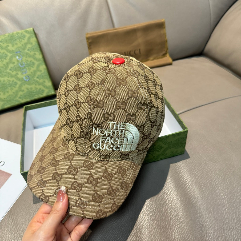 Beige GG monogram baseball cap with “THE NORTH FACE” patch on front and red button