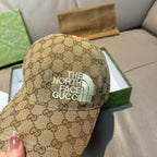 Beige GG monogram baseball cap with teal “THE NORTH FACE” patch on front