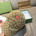 Beige GG monogram baseball cap with red button detail at top and curved brim
