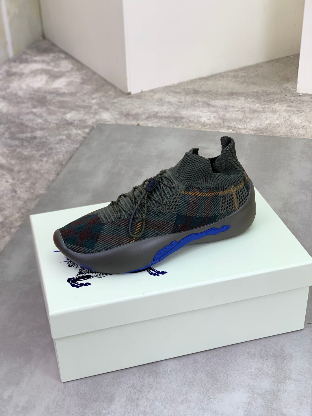 Burberry knit sneakers, dark plaid pattern with blue sole and elastic collar slip-on style
