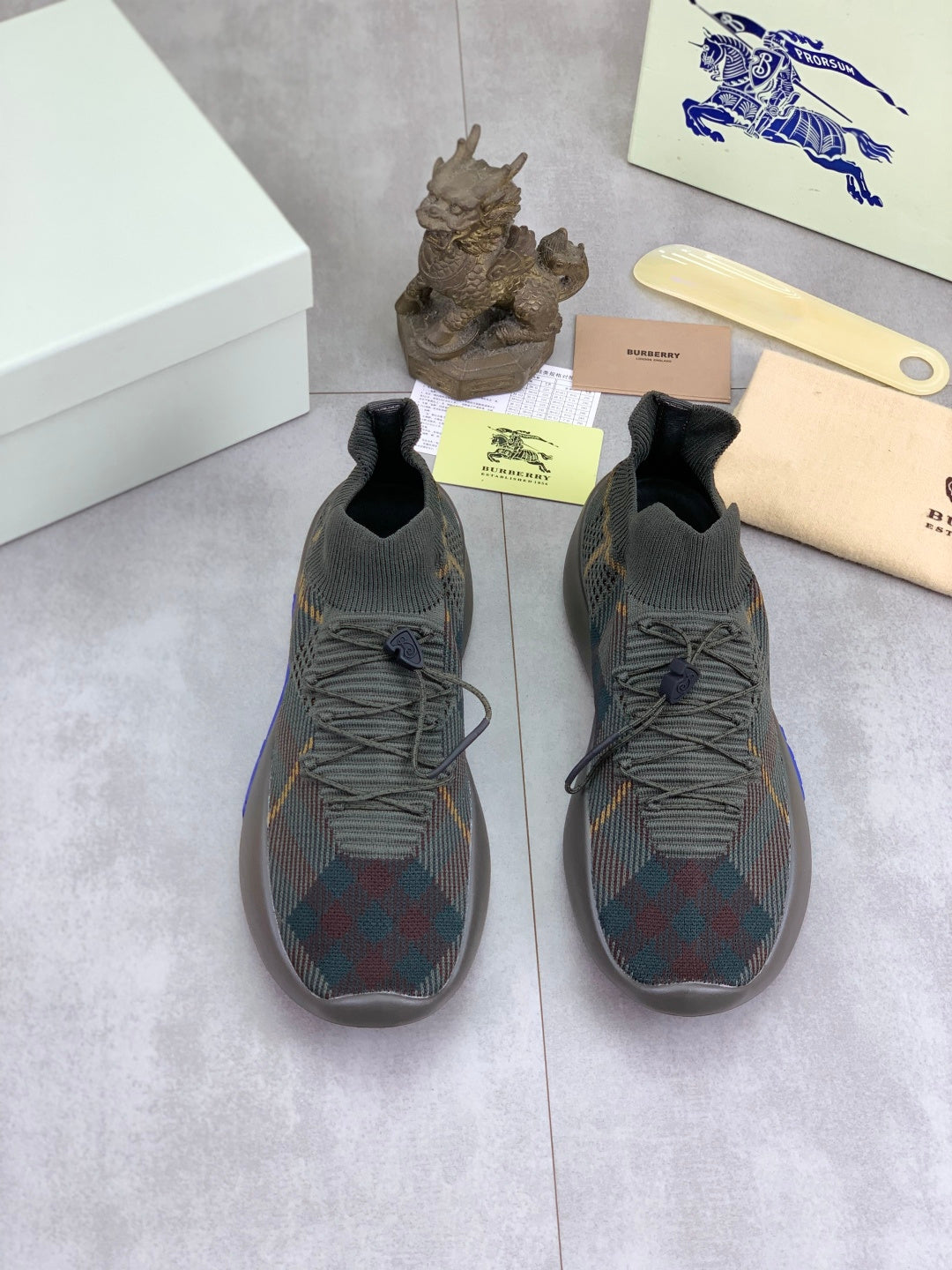 Burberry lace-up knit sneakers, dark plaid upper with blue details, shown pair view