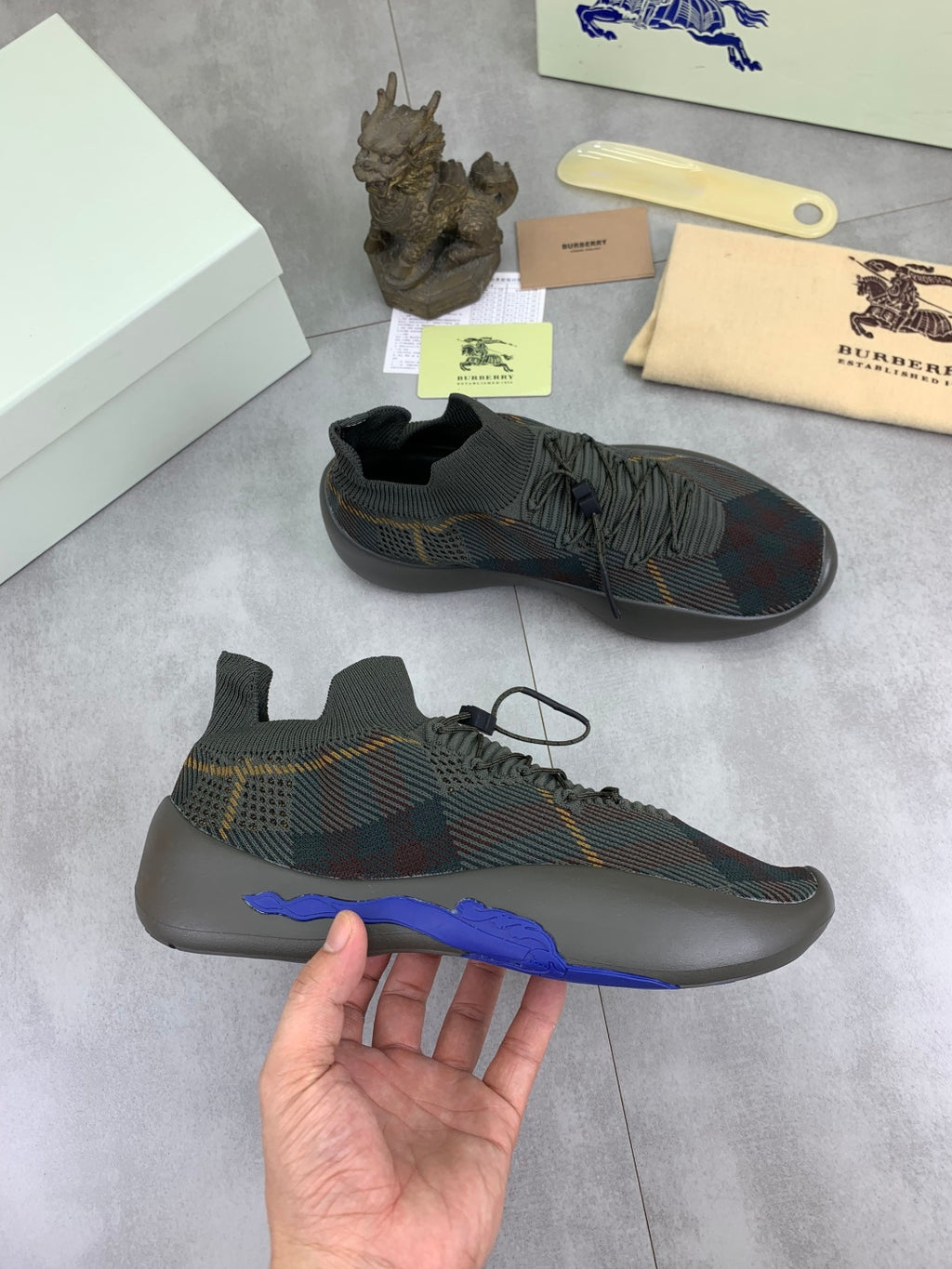Burberry dark plaid knit sneakers with blue sole, hand-held single shoe and lace-up