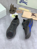Burberry knit sneakers with dark plaid upper and blue side accent, side and heel views